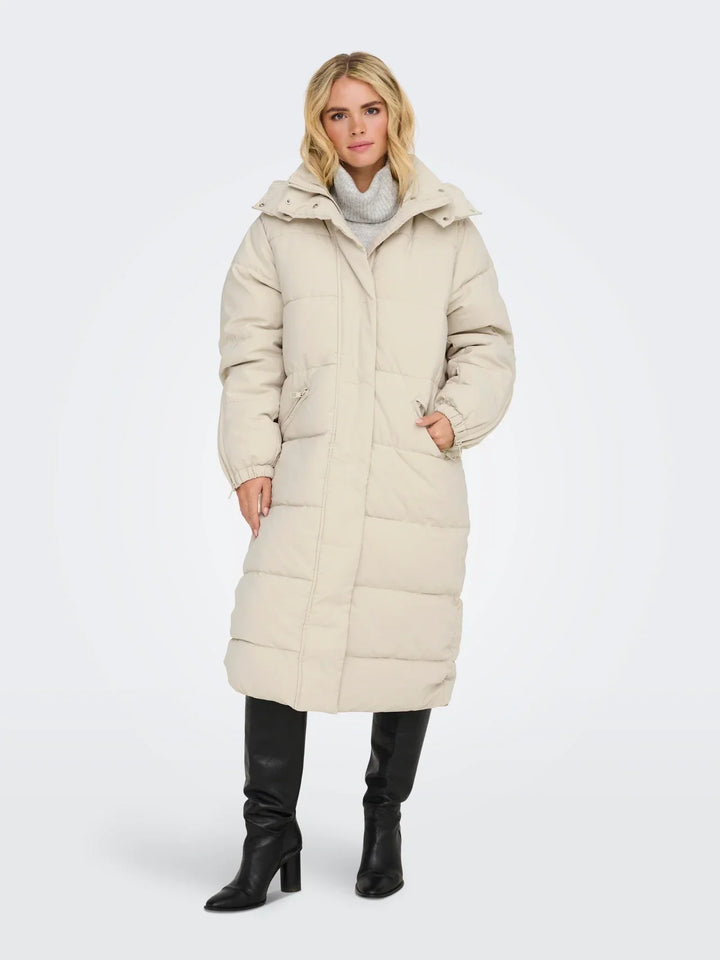 Sorvienne Hooded Longline Puffer Coat in Cream