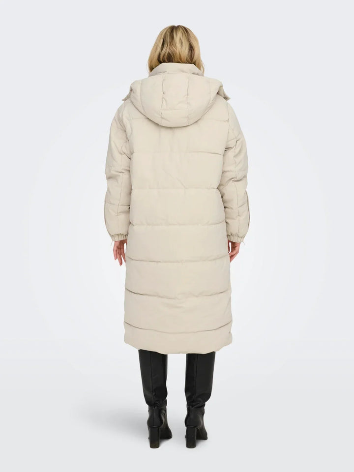Sorvienne Hooded Longline Puffer Coat in Cream