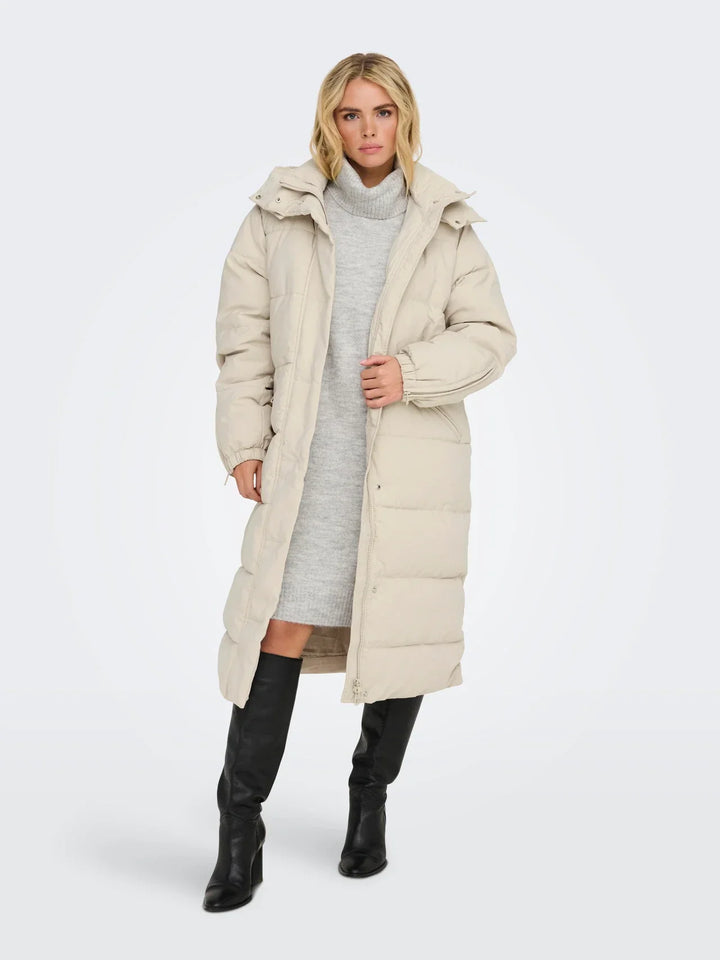Sorvienne Hooded Longline Puffer Coat in Cream