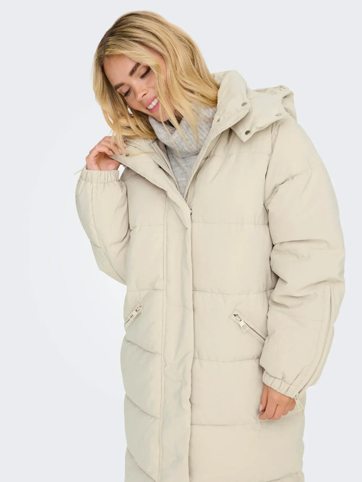 Sorvienne Hooded Longline Puffer Coat in Cream